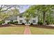 Charming two-story brick home with mature landscaping and a welcoming brick walkway at 640 Saddle Ridge Trce, Roswell, GA 30076