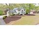 Stately brick home with a well-manicured lawn, mature trees, and a circular driveway at 640 Saddle Ridge Trce, Roswell, GA 30076