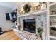 Close-up of the living room fireplace with painted brick, bookshelves, and hearth at 640 Saddle Ridge Trce, Roswell, GA 30076