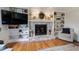 Living room fireplace with painted brick and built-in bookshelves at 640 Saddle Ridge Trce, Roswell, GA 30076