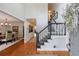 Bright foyer with hardwood floors, staircase, and views into dining room and hallway at 640 Saddle Ridge Trce, Roswell, GA 30076