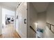 Hallway with wood floors, a view to the living room, and a staircase with a decorative lighting at 640 Saddle Ridge Trce, Roswell, GA 30076