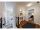Hallway view with stairs, laundry area, and bedroom entrance at 640 Saddle Ridge Trce, Roswell, GA 30076