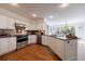 Modern kitchen with white cabinets, stainless steel appliances, granite countertops, and a kitchen island at 640 Saddle Ridge Trce, Roswell, GA 30076