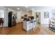 Spacious kitchen with white cabinets, stainless steel appliances, kitchen island, and hardwood floors throughout at 640 Saddle Ridge Trce, Roswell, GA 30076