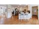 Well-lit kitchen with an island and barstool seating, stainless appliances, and hardwood floors at 640 Saddle Ridge Trce, Roswell, GA 30076