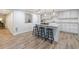 Modern kitchen with white cabinets, a center island with seating, and hardwood floors creating a stylish cooking space at 640 Saddle Ridge Trce, Roswell, GA 30076