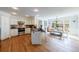 Open concept kitchen with stainless steel appliances, kitchen island, hardwood floors and adjacent dining area at 640 Saddle Ridge Trce, Roswell, GA 30076