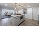 Open-concept kitchen with an island and granite countertops, connecting to a cozy living room at 640 Saddle Ridge Trce, Roswell, GA 30076