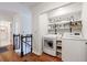 Convenient laundry room with modern washer and dryer units, plus organized shelving at 640 Saddle Ridge Trce, Roswell, GA 30076