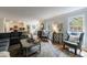 Open living room featuring hardwood floors, a large window, and access to the kitchen at 640 Saddle Ridge Trce, Roswell, GA 30076