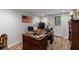 Home office featuring a wooden desk, hardwood floors, and an American flag accent wall providing a professional workspace at 640 Saddle Ridge Trce, Roswell, GA 30076