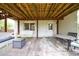 Covered patio features a swing, seating area, and access to the backyard and home at 640 Saddle Ridge Trce, Roswell, GA 30076