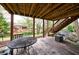 Covered patio with a porch swing and an outdoor table, perfect for relaxation and entertainment at 640 Saddle Ridge Trce, Roswell, GA 30076