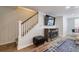 A cozy area featuring a staircase, fireplace, TV, and a stylish ottoman, complemented by a decorative rug at 640 Saddle Ridge Trce, Roswell, GA 30076