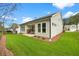 Home's backyard featuring a covered patio, well-maintained lawn, and appealing exterior at 1019 Cooks Farm Way, Woodstock, GA 30189