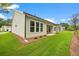 Green backyard with well-kept lawn and a covered outdoor patio at 1019 Cooks Farm Way, Woodstock, GA 30189