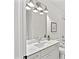 Modern bathroom featuring a marble countertop, stylish fixtures, and neutral tones, with a framed art piece at 1019 Cooks Farm Way, Woodstock, GA 30189