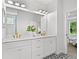 Bathroom featuring double vanity, quartz countertop, gold hardware, and black and white patterned tile floor at 1019 Cooks Farm Way, Woodstock, GA 30189