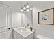 Modern bathroom featuring a marble countertop, stylish fixtures, and neutral tones, with a framed art piece at 1019 Cooks Farm Way, Woodstock, GA 30189