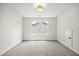Bedroom features a neutral carpet, window, and closet at 1019 Cooks Farm Way, Woodstock, GA 30189