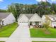 Charming home featuring a two-car garage, covered entryway, and well-manicured lawn at 1019 Cooks Farm Way, Woodstock, GA 30189