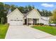 Charming home featuring a two-car garage, covered entryway, and well-manicured lawn at 1019 Cooks Farm Way, Woodstock, GA 30189
