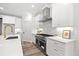 Gourmet kitchen featuring stainless steel appliances, quartz countertops, and tile backsplash at 1019 Cooks Farm Way, Woodstock, GA 30189
