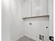 Clean laundry room features gray floors and white cabinets at 1019 Cooks Farm Way, Woodstock, GA 30189