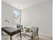 Bright office space with neutral walls, desk, and two chairs, illuminated by natural light from a large window at 1019 Cooks Farm Way, Woodstock, GA 30189
