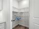 Well-organized pantry with metal shelving, providing ample storage space; light wood-look flooring at 1019 Cooks Farm Way, Woodstock, GA 30189