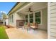 Covered patio featuring a brick fireplace and seating area, perfect for relaxing outdoors at 1019 Cooks Farm Way, Woodstock, GA 30189