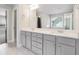 Bathroom featuring double sinks, quartz countertops, and views of the backyard at 3002 Blue Stone Ct, Dacula, GA 30019