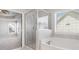 Bathroom featuring a soaking tub, glass-enclosed shower, and ample natural light at 3002 Blue Stone Ct, Dacula, GA 30019