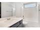 Bright bathroom featuring a shower-tub combo, modern vanity, and a window above the shower at 3002 Blue Stone Ct, Dacula, GA 30019