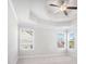Spacious bedroom featuring trey ceilings, a ceiling fan, and bright windows at 3002 Blue Stone Ct, Dacula, GA 30019