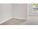 Walk-in closet featuring neutral carpet, wire shelving, and a large window for natural light at 3002 Blue Stone Ct, Dacula, GA 30019