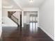 Bright entryway featuring hardwood floors, white walls, and a staircase with dark iron railing at 3002 Blue Stone Ct, Dacula, GA 30019