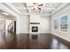 Cozy living room featuring a fireplace, coffered ceiling, and hardwood floors at 3002 Blue Stone Ct, Dacula, GA 30019