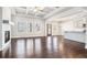 Open-concept living room featuring hardwood floors, fireplace, and a view of the kitchen at 3002 Blue Stone Ct, Dacula, GA 30019