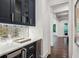 Chic bar area with custom cabinets, wine fridge, and geometric backsplash at 369 Pinecrest Ne Rd, Atlanta, GA 30342