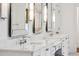A bathroom with double sinks, white marble counters and decorative mirrors at 369 Pinecrest Ne Rd, Atlanta, GA 30342