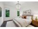 This bedroom features hardwood floors, two windows, and decorative lighting fixture at 369 Pinecrest Ne Rd, Atlanta, GA 30342