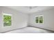 Bright bedroom with plush gray carpeting and two windows offering natural light at 369 Pinecrest Ne Rd, Atlanta, GA 30342