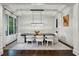 Elegant dining room with wainscoting, modern lighting, and seating for six at 369 Pinecrest Ne Rd, Atlanta, GA 30342