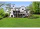Back exterior view of the home, showcasing the screened porch, deck, and landscaped yard at 369 Pinecrest Ne Rd, Atlanta, GA 30342