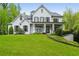 Elegant white brick home with symmetrical design, dark shutters, and manicured lawn at 369 Pinecrest Ne Rd, Atlanta, GA 30342
