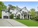 Stunning two-story home with painted brick, a side-entry garage, and lush landscaping at 369 Pinecrest Ne Rd, Atlanta, GA 30342