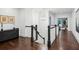 A long hallway features hardwood floors, dark banisters, and neutral walls at 369 Pinecrest Ne Rd, Atlanta, GA 30342
