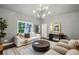 Cozy living room features modern lighting, a large rug, and comfortable seating at 369 Pinecrest Ne Rd, Atlanta, GA 30342